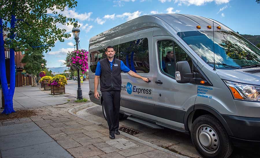 Summit Express shuttle van parked in Vail Village providing airport transportation and private car service in Vail Colorado